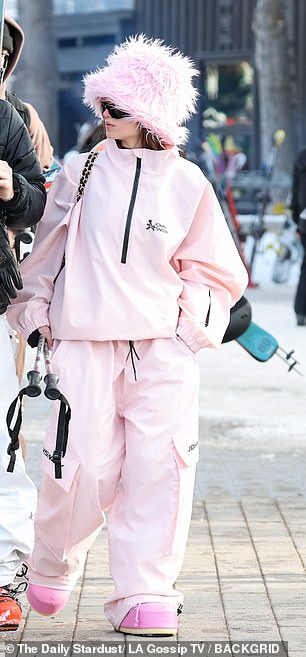 She paired a pink faux fur hat with a matching John Snow 'Mountain Dope Freestyle' two-piece snowsuit worth $280