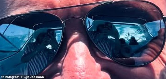 But one photo caught the attention of several fans who noticed a woman in the reflection of his sunglasses during his boat day