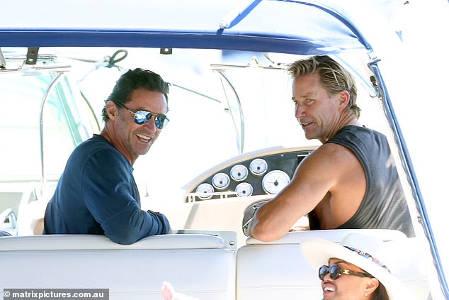 Hugh's friend Michael Ryan was on the boat, as well as his sister and another woman wearing a wide-brimmed hat - who took the photos of Hugh (pictured sitting below Michael)