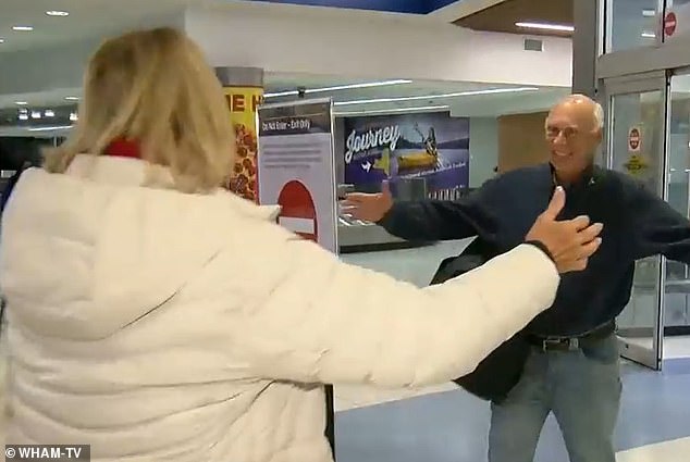 Dixon ran to hug his sister, Wendy Gell, left in the baggage claim at Rochester Airport