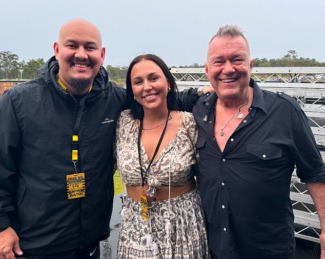 Katy Lee Carrol is pictured between her father Jimmy Barnes and her half-brother Jackie Barnes. Katy and Jackie wear cold chisel strap passes