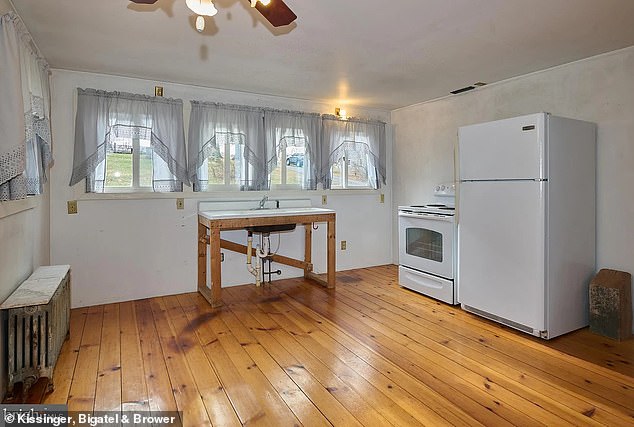 The house features a 13x15 kitchen with hardwood floors, a stove, refrigerator, ceiling fan and an abundance of natural light