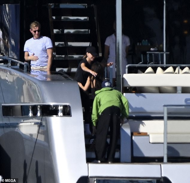 Victoria hugged Jackie as they soaked up the sun on the deck of the yacht