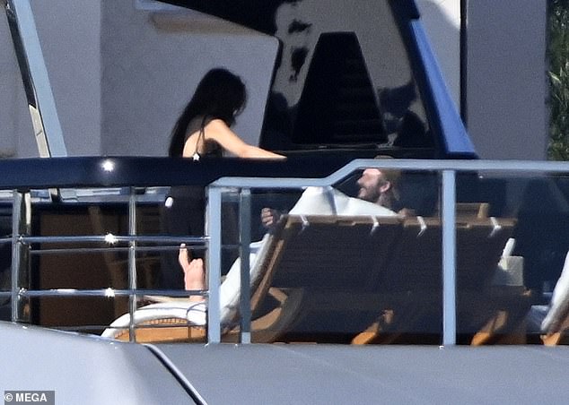 Jackie was also seen walking up to David for a cuddle as he soaked up the sun on the deck