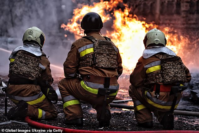 Rescue workers respond to the site of falling fragments of Russian ballistic missiles in the Holosiivskyi district of the city on December 20, 2024 in Kiev