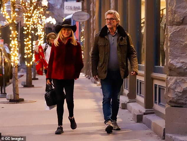 For the busy outing, Goldie wore a glamorous red fur jacket, black cowboy hat and boots and topped it off with black leggings.