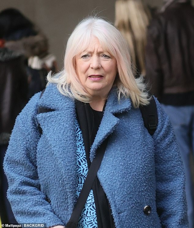 The actress, who plays Pam, is dressed in a fluffy blue coat