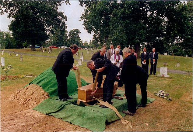 The body is lowered to his grave in Haywards Heath, Sussex