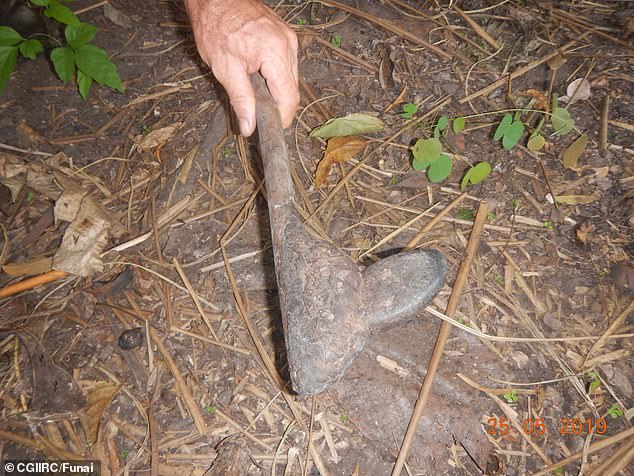 The photo shows a stone weapon found in a suspected settlement in Massaco