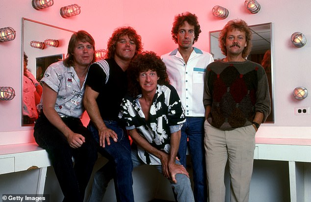 Cronin (center) joined the group as a singer in 1972. The band had great success in the 1980s with hits such as Keep On Lovin' You and Take It On The Run (photo left with Bruce Hall, Gary Richrath, Alan Gratzer and Neal Doughty in Detroit in December 1985)