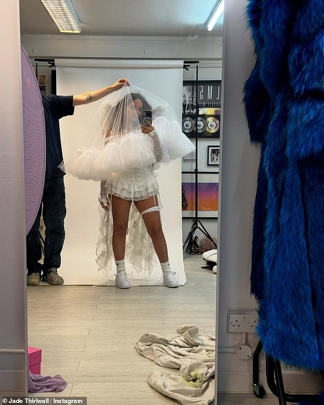 In the snap, the pop star posed as a bride-to-be as an assistant held a veil over her face