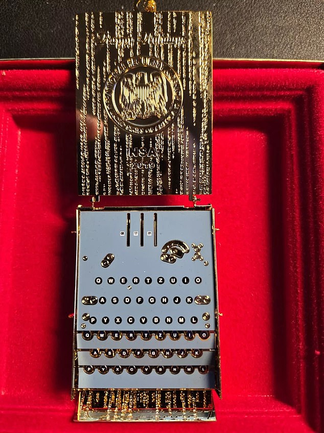 The 2019 Enigma machine ornament opens (photo above) to reveal the small typewriter used to encode the encrypted and decrypted messages of World War II