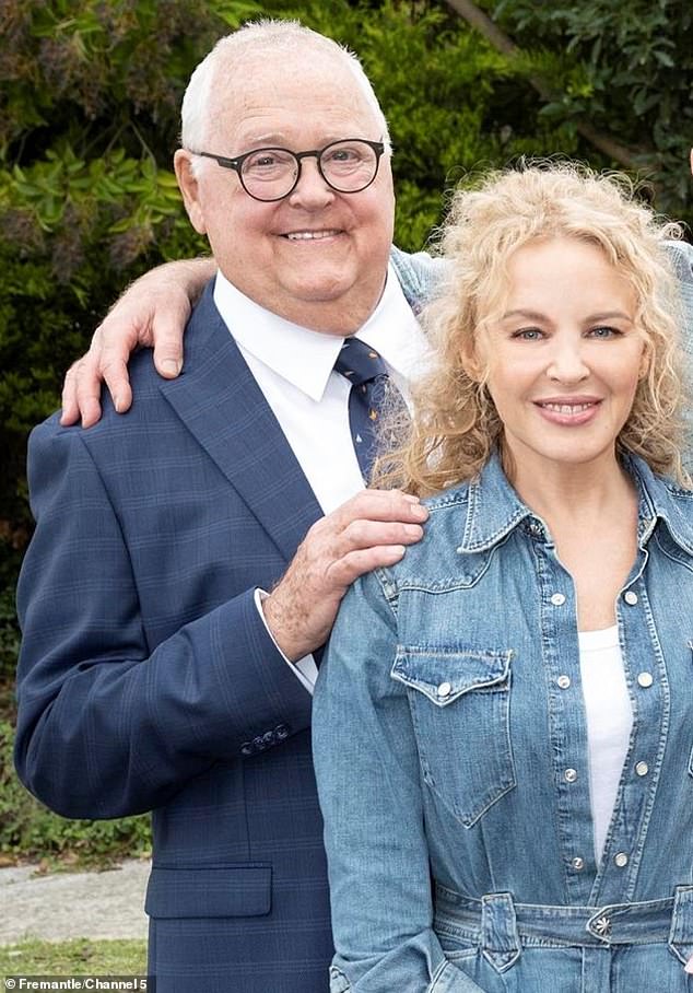 Kylie is seen leaning on fellow actor Ian Smith, who has appeared regularly on the series since 1987 as Harold Bishop