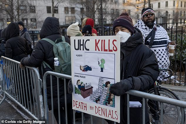 A protester holds a sign outside the Manhattan Criminal Court on December 23, 2024 in New York City