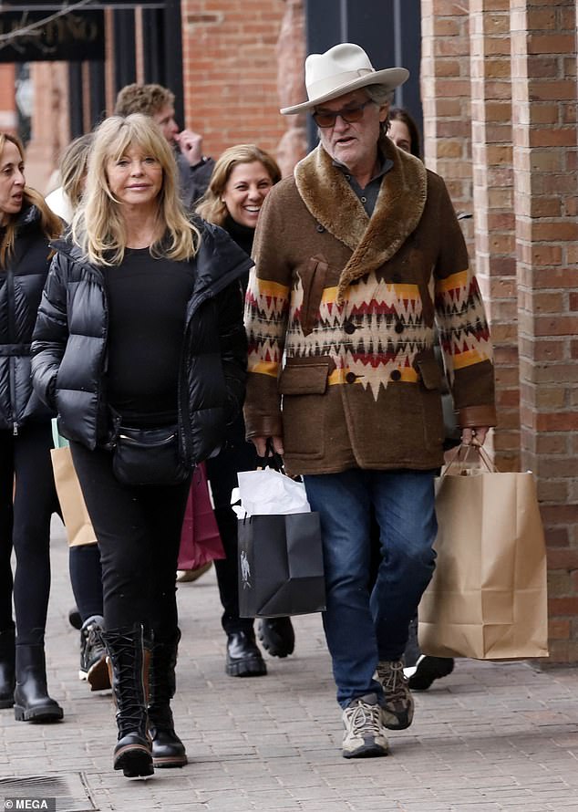 The couple appeared to be doing some last-minute Christmas shopping when Russell, 73, was spotted carrying large paper shopping bags. Goldie presented herself stylishly in an all-black outfit with a cozy puffer jacket, long-sleeved top and comfortable leggings