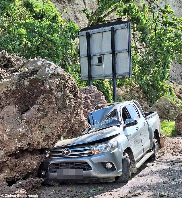 Large boulders crushed and blocked roads in landslides after the earthquake flattened buildings and killed 12 people