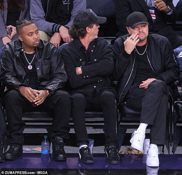 Rapper Nas (left) was also in attendance and opted for a head-to-toe black outfit