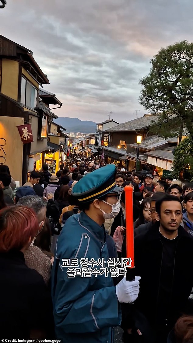 Authorities were even forced to divert traffic through the narrow, 400-metre-long cobbled street, with one travel blogger describing Kyoto as the 'seventh ring of hell now'.