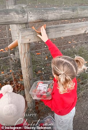 The cute youngsters wore matching red sweaters with the text: 'little believer'