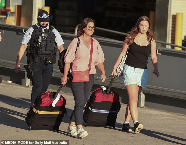 Tanya Sandoe, 56, and her 19-year-old daughter Georgia Sandoe-Simpson are pictured arriving home on December 16 after also being hospitalized due to the mass poisoning