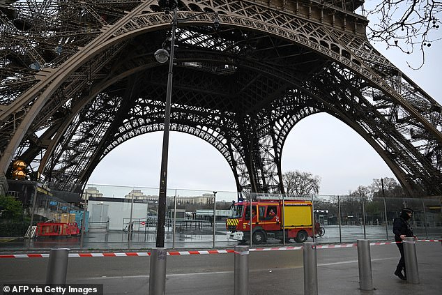 This photo shows firefighters in their vehicle stationed at the base of the Eiffel Tower, where a fire was reported in Paris on December 24