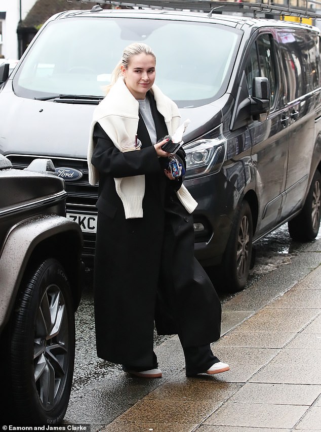 Making her way through the rainy village, Molly-Mae was seen juggling a Costa coffee, a snack, her phone, a camera and her keys between her two hands.