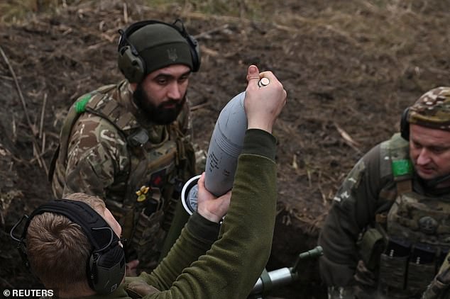 Members of the Consolidated Brigade 'Khyzhak' (Predator) of the Ukrainian Patrol Police place a grenade in a mortar while firing at Russian troops at their position in a front line near the city of Toretsk, amid the Russian attack on Ukraine, in Donetsk region , Ukraine December 20, 2024