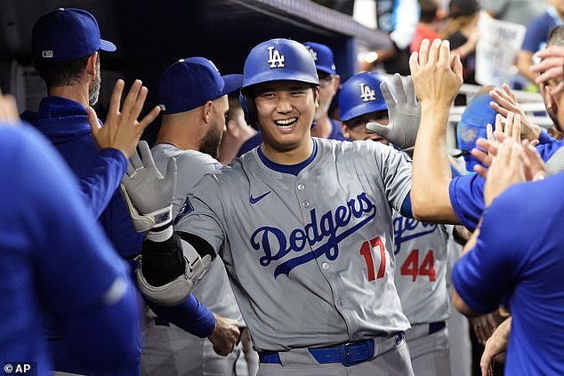 Shohei Ohtani, 17, celebrates in the dugout after hitting a home run during the sixth inning of a baseball game against the Miami Marlins, Thursday, September 19