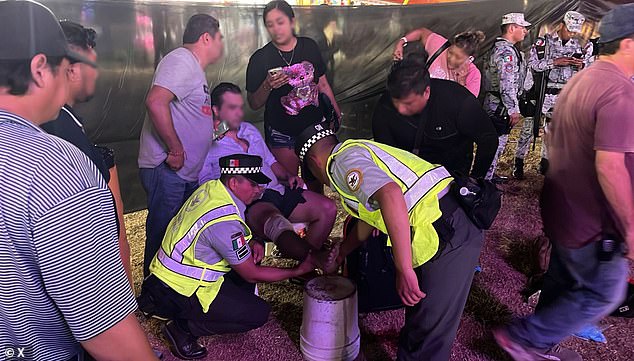 Mexico's National Guard provides aid to one of the two men who were injured