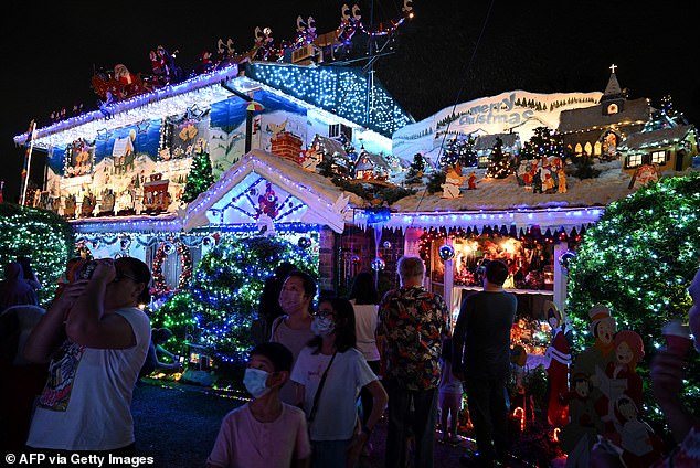 The Armenian-Syrian twin sisters, who now live in Sydney's multicultural west, put up a Christmas tree and decorations to celebrate the festivities (pictured, residents in Sydney's west visit a house decorated with Christmas decorations)