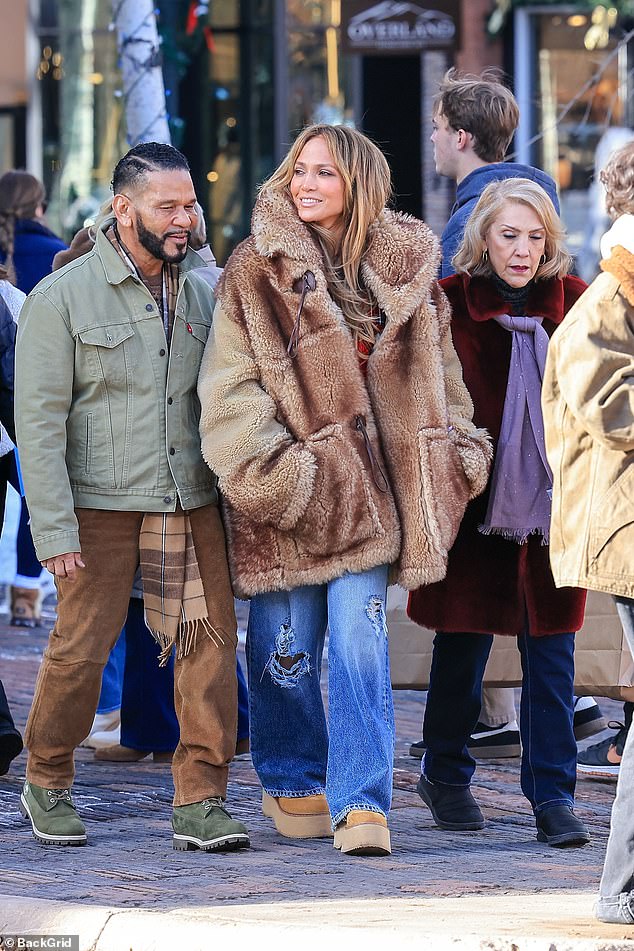 Her mother Guadalupe showed off her Christmas spirit with a fluffy red coat, while manager Benny Medina wore a timeless olive Levi's trucker jacket