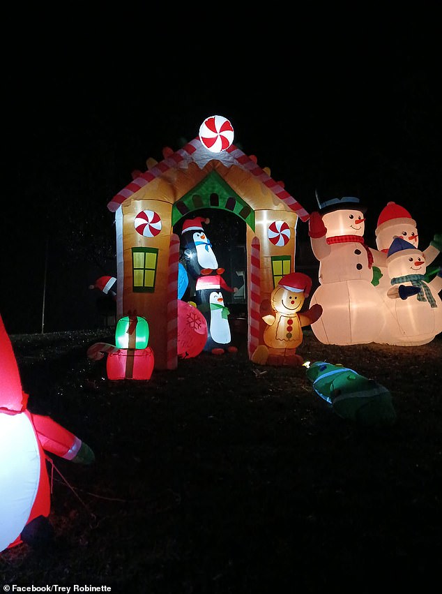 In the photo: a gingerbread house, snowmen and penguins that are now in Robinette's front yard