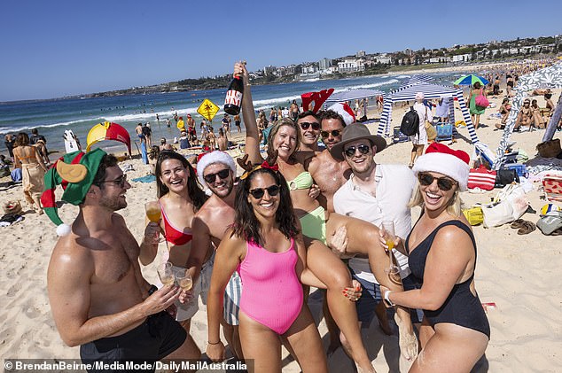 We see a group of friends enjoying champagne while going to the beach for Christmas