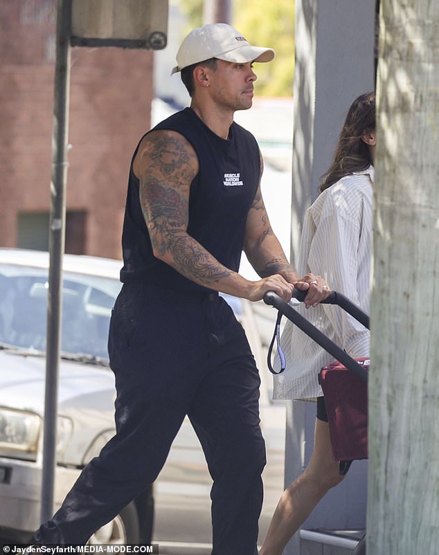 Completing his monochrome look with Adidas sneakers and a white baseball cap, he appeared excited to embrace fatherhood as he pushed his son's stroller down Sydney's scenic street.