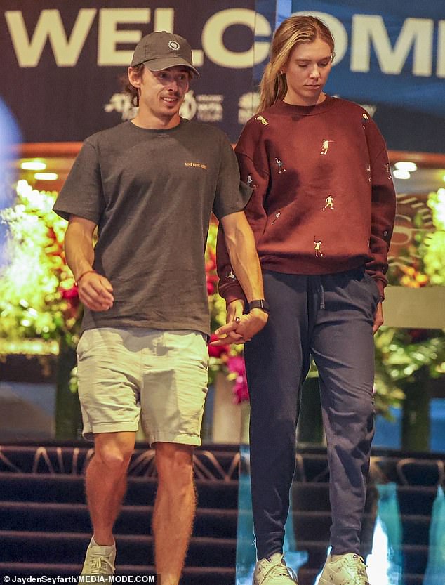 The Australian tennis pro affectionately linked his fingers through hers during their low-key outing