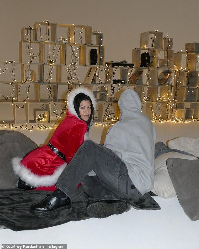 Travis kept it relaxed with a gray graphic hoodie and charcoal jeans