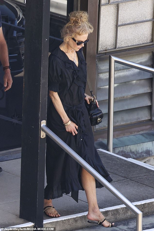 Stepping out for the Christmas Day service, Nicole looked elegant in a black dress with a ruffled neckline, which she styled with dark sandals.