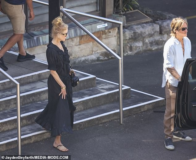 Keith looked equally smart in a powder blue shirt and beige chinos, which he teamed with a pair of black trainers and aviator sunglasses.