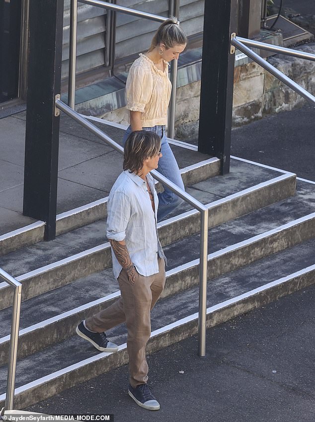 Sunday wore a yellow top and blue jeans as she stepped out of the church next to Keith