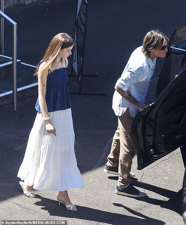 Faith wore a blue and white dress and heeled sandals to the church service on Christmas Day