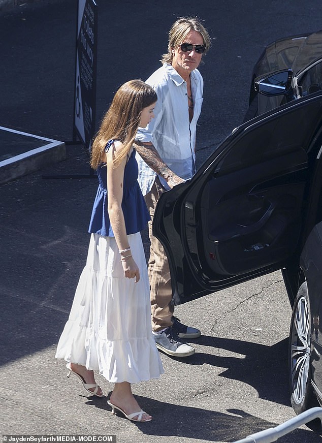 Keith was seen holding the car door open for his youngest daughter Faith as they left the church to continue their Christmas celebrations