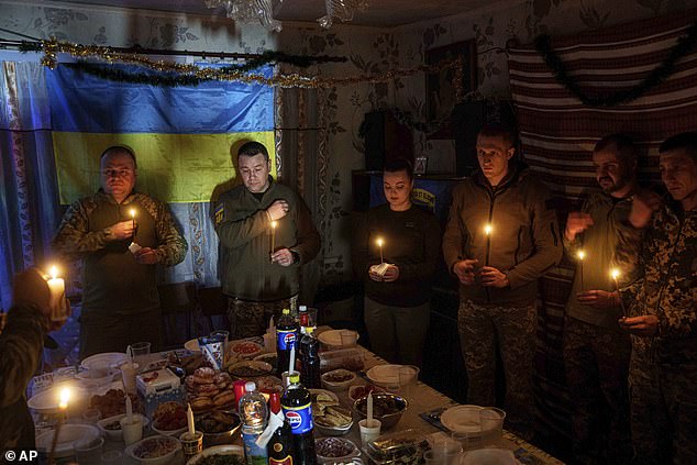 Ukrainian soldiers of the 117th Separate Heavy Mechanized Brigade pray for a Christmas dinner in the direction of Pokrovsk on December 24