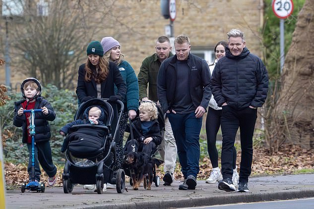 Gordon looked delighted as he cut a casual figure, clad in a black padded jacket and joggers as the group walked their family dog, Cocker Spaniel Bruno