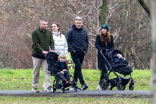 Adam looked dapper in tan trousers and a green jacket, while Holly kept warm in a white padded coat