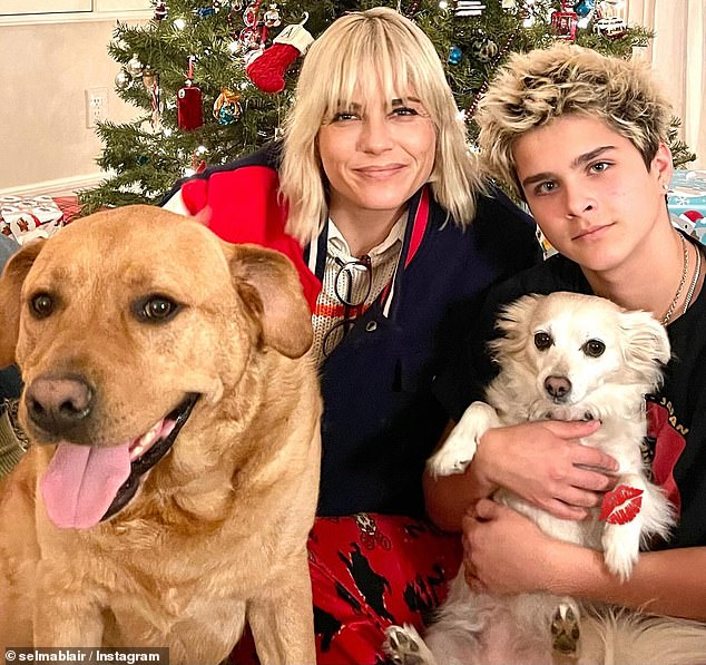 Selma Blair, meanwhile, was pictured at the base of her tree with her dogs and her son Arthur Bleick, 13, who she had with her fashion designer ex Jason Bleick