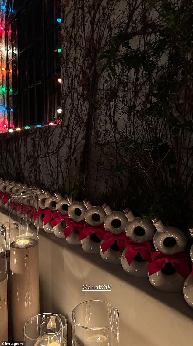 The model also shared a photo of a wall lined with bottles of her backup tequila, warmly lit by tall candles and strings of colorful Christmas lights.