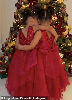 The little twins are captured in a series of shots from behind as they embrace