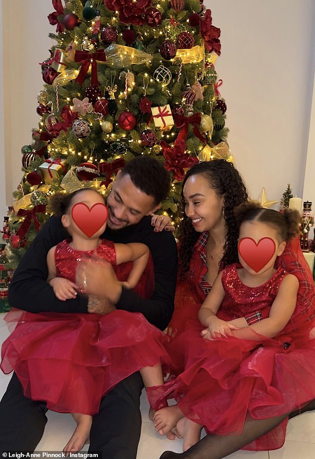 Leigh-Anne and the footballer gently rocked their daughters as they enjoyed the Christmas festivities.