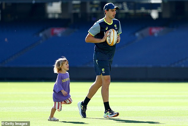 Australian skipper Pat Cummins is pictured running at the Melbourne Cricket Ground with his son Alfie on Christmas Day