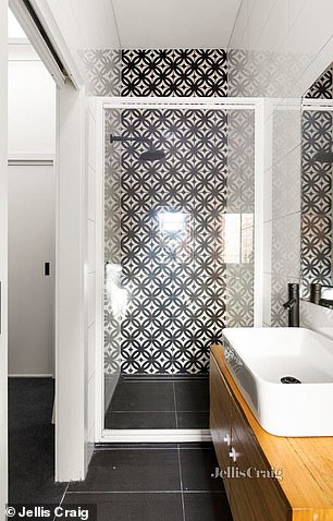 Black and white tiles continue throughout the ensuite and family bathroom, creating a cohesive aesthetic